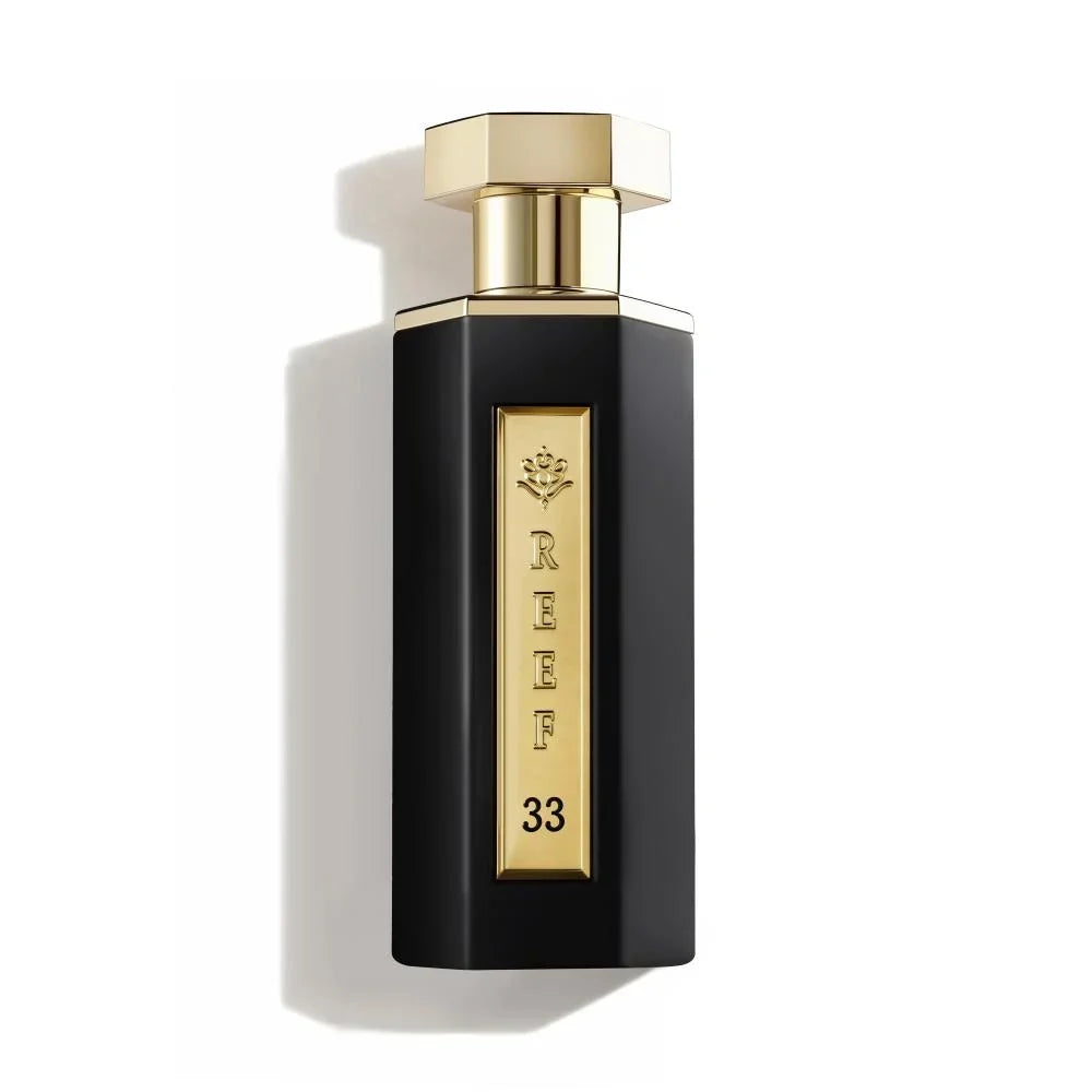 Black and gold perfume bottle labeled 'REEF 33' on a white background